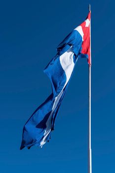 Waving Cuba flag and blue sky during sunny day