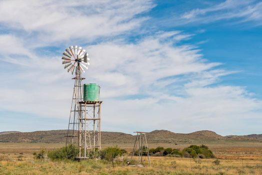 A water-pumping windmill and water tank on a farm near Hanover in the Northern Cape Karoo