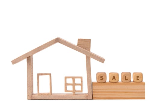 Wood model house and text on wooden "SALE" .Concept for real estate, moving home or renting property. Isolate White background.