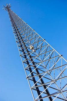 Climber ascending the cellular tower. Illinois, USA.