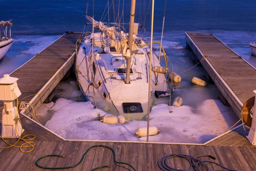 Forgotten yacht during the winter. Illinois, USA.