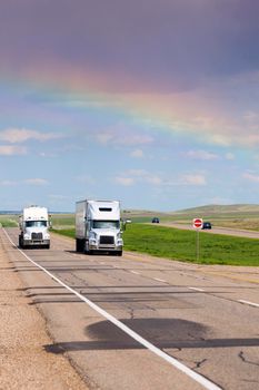 Rainbow over the highway in Saskatchewan. Saskatchewan, Canada.