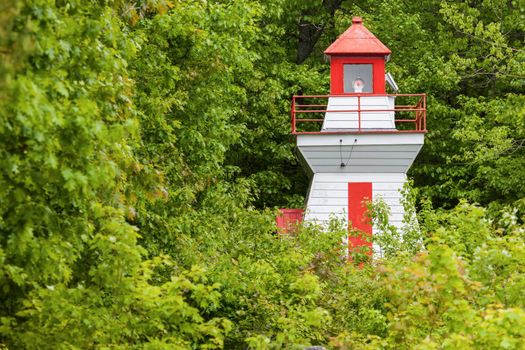 Wilson Channel Lighthouse and green trees. Ontario, Canada.