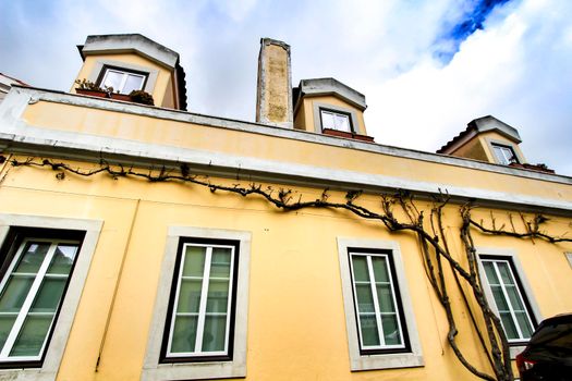 Old colorful and beautiful facades with vintage streetlight in Lisbon streets in Spring.