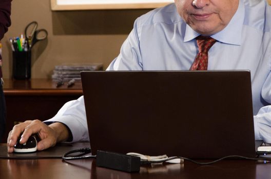 Business man working at office with laptop and documents on his desk