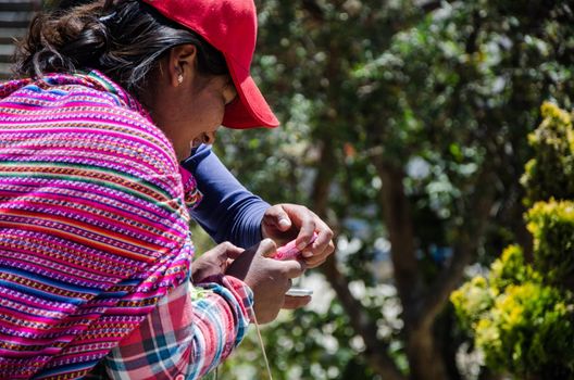 Lima, Peru - 2 SEPTEMBER 2018: A happy young girl from the Andes with a cell phone in her hand