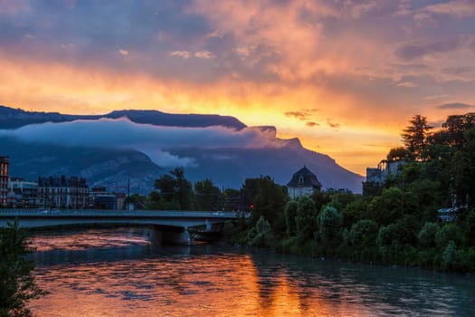 Grenoble architecture along Isere River seen at sunset. Grenoble, Auvergne-Rhone-Alpes, France.