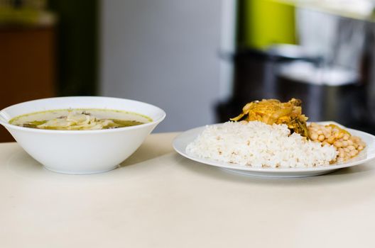 Delicious homemade food, noodle soup and beans with rice and chicken, concept of homemade food