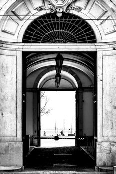 Beautiful archway with vintage lantern overlooking the Tagus River in Lisbon