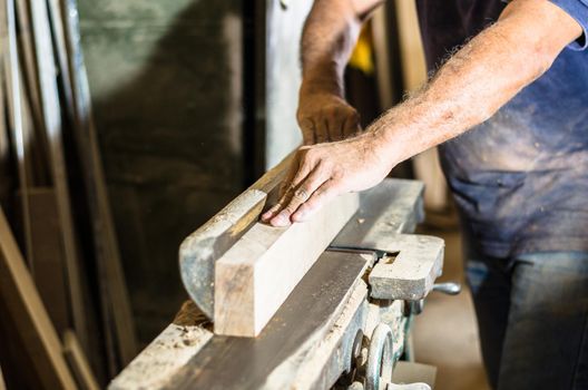 Carpenter tools on wooden table with sawdust. Cutting a wooden plank