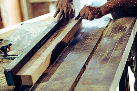 Carpenter tools on wooden table with sawdust. Cutting a wooden plank