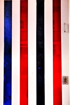 Old and colorful striped wooden door with iron details in Lisbon, Portugal
