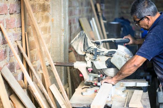 Circular saw for cutting boards into the hands of the professional carpenter, construction and home renovation, repair and construction tool