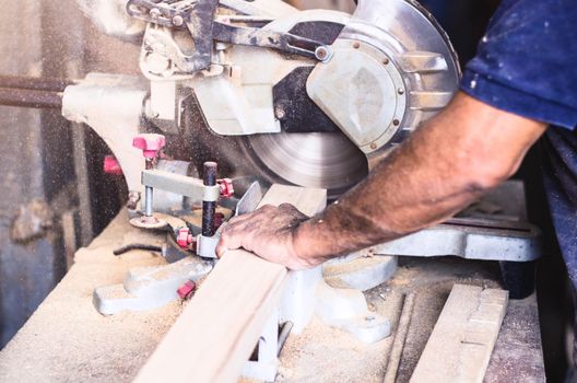 Circular saw for cutting boards into the hands of the professional carpenter, construction and home renovation, repair and construction tool