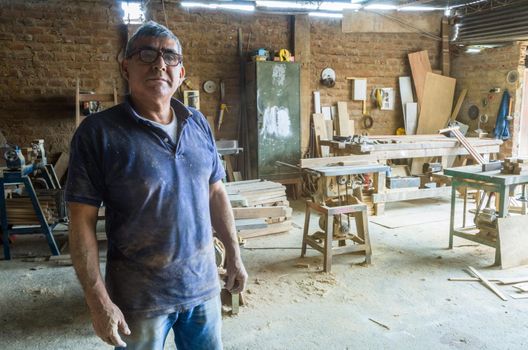 Portrait of senior carpenter in his workshop