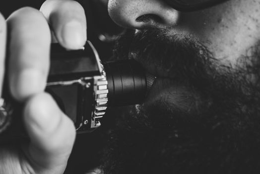 Close up of an unrecognizable young man smoking from a vape pen or vaporizer