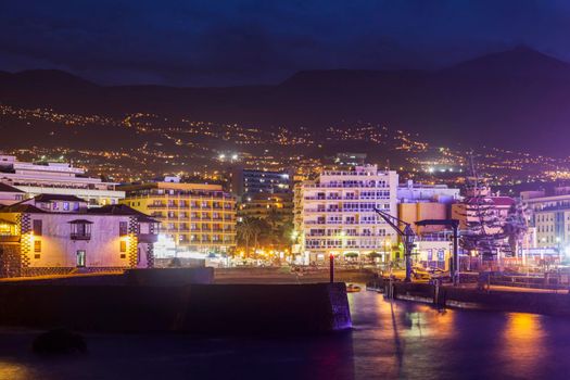 Puerto de la Cruz at night and Teide in the background Puerto de la Cruz, Tenerife, Canary Islands, Spain.