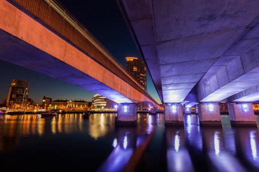 Belfast architecture along River Lagan and illuminated bridge. Belfast, Northern Ireland, United Kingdom.