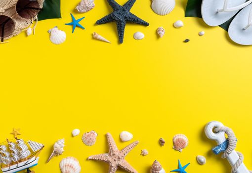 Summer beach design concept. Top view of holiday travel with shells, hat, slipper on yellow background.
