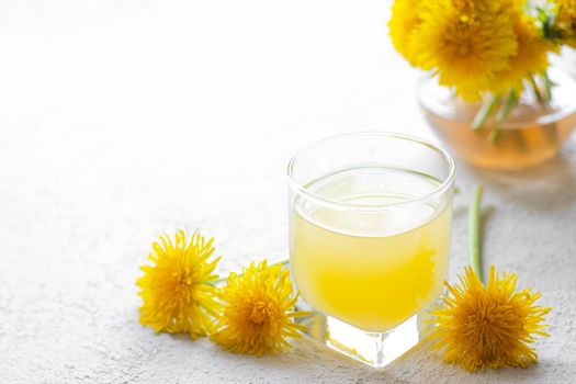 Dandelion tea. Yellow summer flowers dandelions. Tea party Homemade drink. Certified flower tea. Yellow drink. An article about teas. Hot drinks article