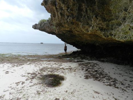 Tourist woman looking at the ocean during low tide, Kenya