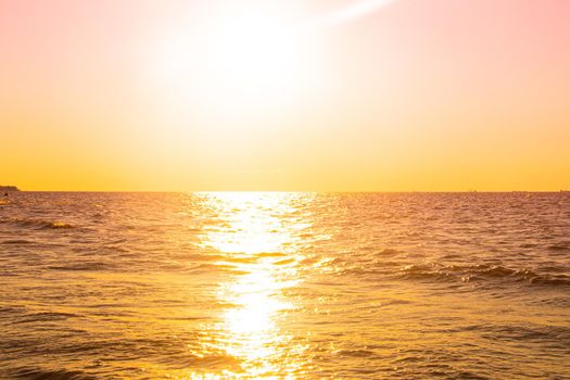 Sunset at sea. Warm sunny sunset over the sea. Sea waves. The sun sets over the horizon. The Gulf of Finland