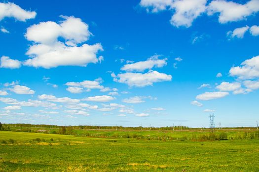 Summer Sunny landscape in the field. Beautiful summer landscape. Photos in the daytime in sunlight. nature of Russia. Green grass and blue sky.