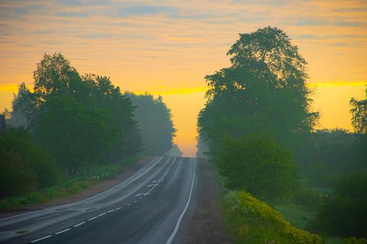 Highway at dawn . Beautiful road. Road landscape. Travel by car. The article is about travel.