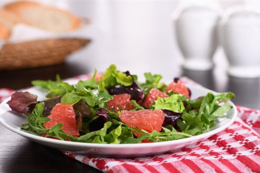 Grapefruit salad, a mix of lettuce, arugula and olive dressing. Dietary menu. Proper nutrition. Vegetarian food.