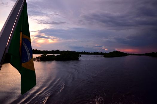 Rio Negro waters and the jungle at sunset, Amazon, Brazil.