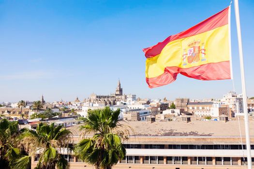 Panorama of Seville with the Cathedral and Spanish flag. Seville, Andalusia, Spain.