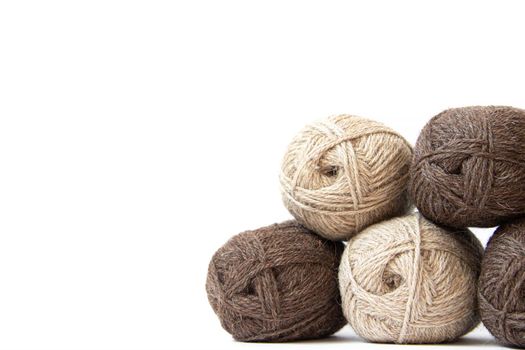 Wool yarns for knitting. Wool thread for knitting. Own hand. Knitting and needlework. Yarns for a scarf, sweater, and socks. Copy space . Balls of yarn
