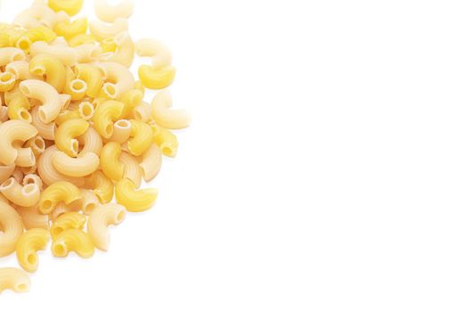 Macaroni horns isolated on a white background. Durum macaroni. Copy space. Article about pasta. Cooking pasta dishes