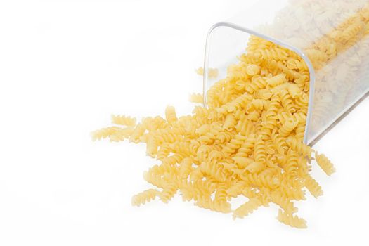Fusilli macaroni placer . Macaroni spills out of the jar. Article about pasta. Isolated background. Copy space Macaroni. Macaroni banner