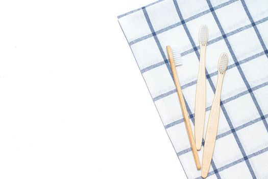 Bamboo toothbrush on a towel. Tooth cleaning. Article about choosing a toothbrush. Article about dental care. Bath accessories. Collection on vacation. The towel in the box. Natural material. Eco-products. No plastic surgery. Concern for the environment.