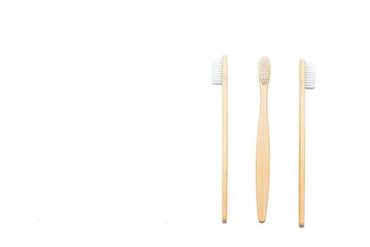 Bamboo toothbrush on an isolated background. Tooth cleaning. Article about choosing a toothbrush. Article about dental care. Bath accessories. Collection on vacation. Natural material. Eco-products. No plastic surgery. Concern for the environment. Copy space.