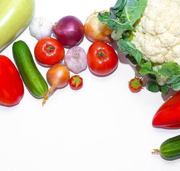 Vegetables layout on a white background . Home-grown vegetables. Harvest. Window dressing. Isolated vegetables. Article about vegetables. Agricultural industry. Copy space