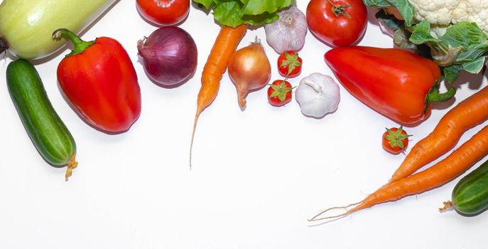 Vegetables layout on a white background . Home-grown vegetables. Harvest. Window dressing. Isolated vegetables. Article about vegetables. Agricultural industry. Copy space