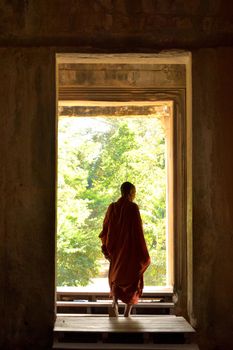 January 3rd 2017, Cambodia, Buddhist monk coming out of one of the doors of the Angkor Wat temple