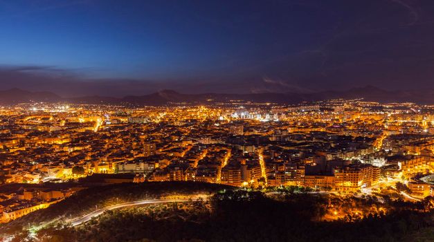 Aerial panorama of Alicante at night. Alicante, Valencian Community, Spain.