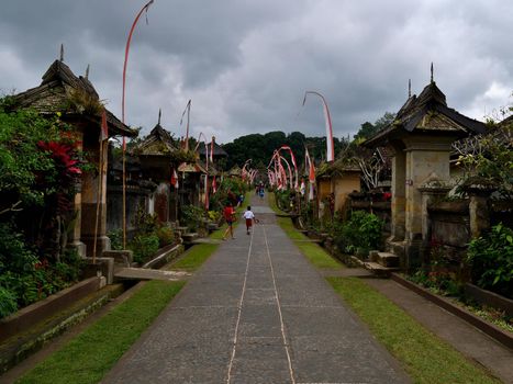 Penglipuran village in a cloudy day, Bali, Indonesia: the main street and its houses