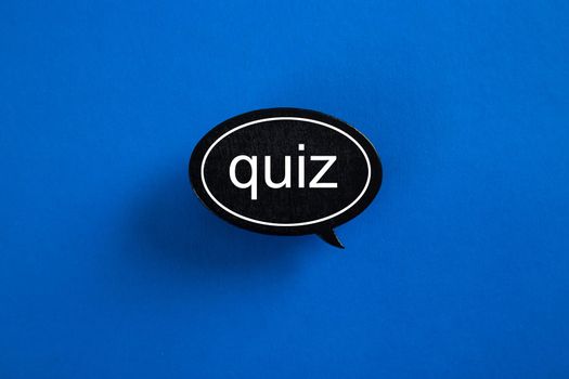QUIZ with speech bubbles on blue background - concept.