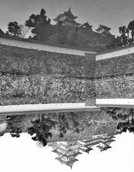 View upside down and reflected in the artificial pond of the Himeji castle, Japan