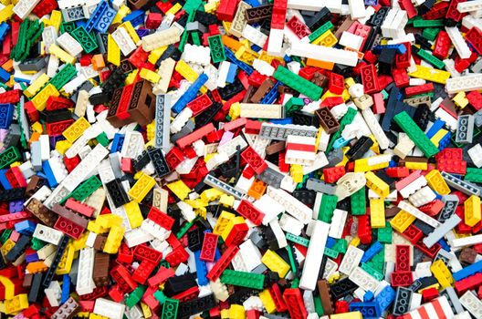 Multicolored plastic building blocks of the designer. Background of bright plastic building blocks.