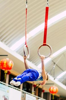 Portrait of little kid gymnast in a championship.