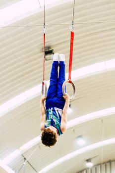 Portrait of little kid gymnast in a championship.