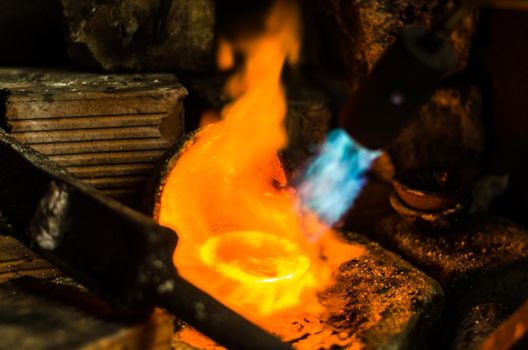 A melted silver in a jewelry workshop, melting silver.