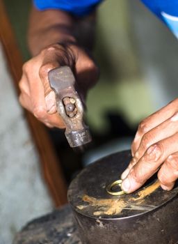 The process of making gold jewellery. Hammering the gold ring. Crafting a gold ring, see the entire series.