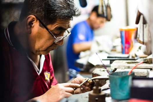 Craft jewelery making. Ring repairing. Putting the diamond on the ring.