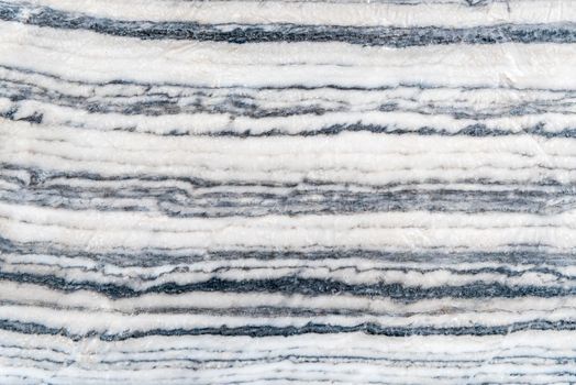 Smooth surface texture line overlap of stone, White and black color striped wave pattern of marble, Strong structure durable nature of rock for abstract background
